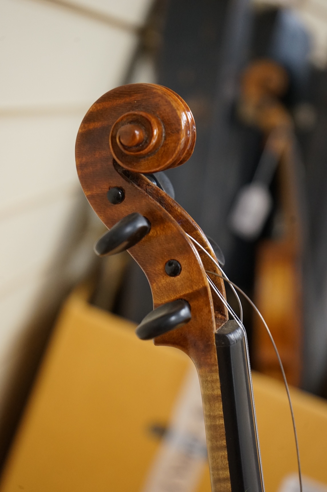 Three violins; a late 19th century German Stradivarius pattern violin, without label, a handmade violin (a.f.), with sound post crack, broken and repaired scroll, etc. and a Maidstone violin body, varnish stripped from t